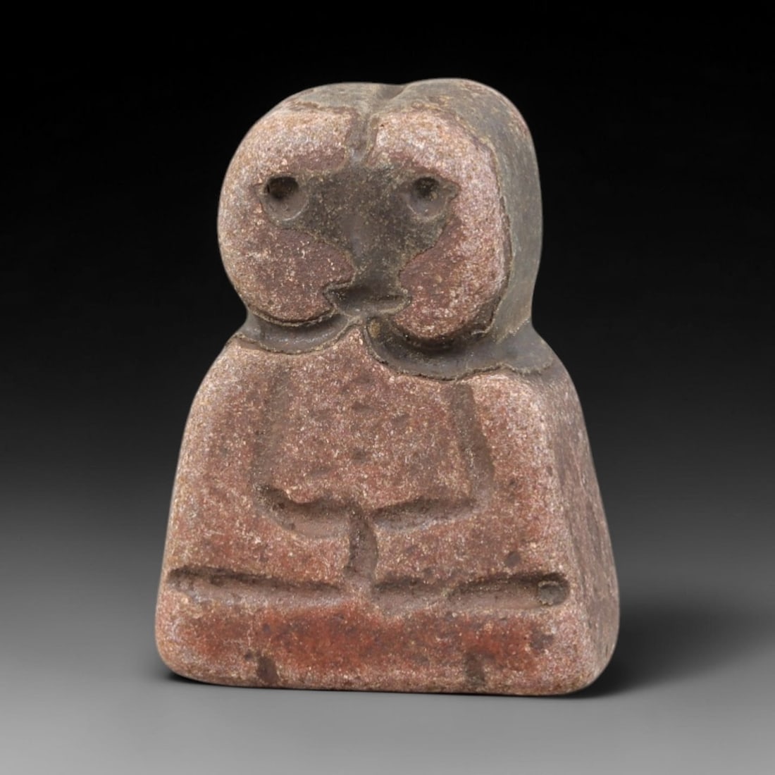 Ancient Stone Idol - Near Eastern Figurine, 11FY: Carved from a bell-shaped stone, this idol features a stylized head with a split upper contour, circular eye perforations, and a simplified facial motif, paired with a torso incised with a vertical tr
