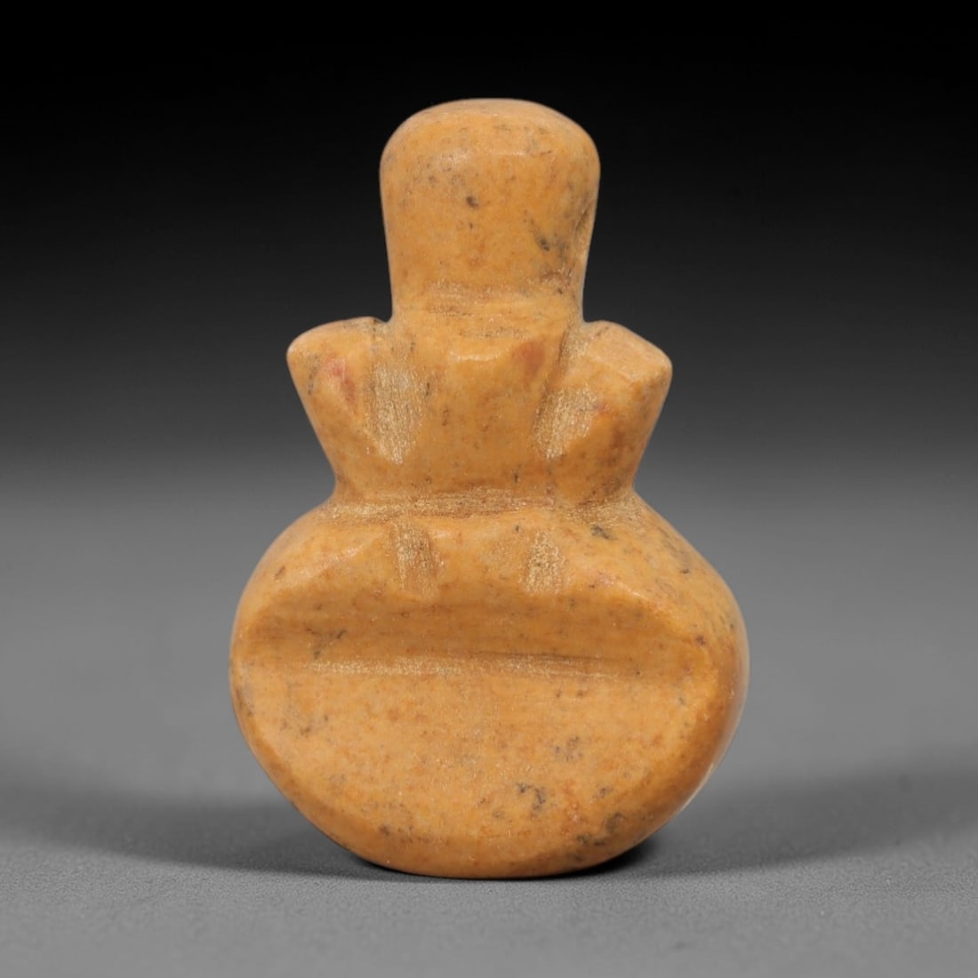 Ancient Egyptian Stone Amulet - Geometric Carved Pendant, 33AE: Carved from light-toned stone, this ancient Egyptian amulet features an oval form with incised geometric detailing, a motif typical of Egyptian protective amulets. Craftsmanship is simple yet delibera