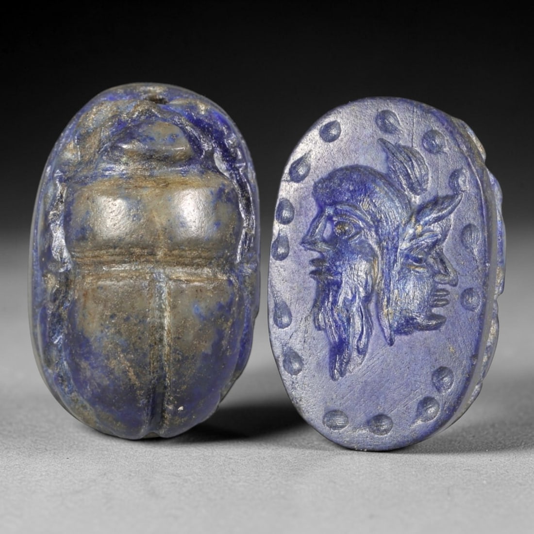 Ancient Lapis Lazuli Scarab - Near Eastern Janiform Seal, 73AS: This artifact is hand-carved from lapis lazuli, utilizing traditional ancient lapidary techniques consistent with Near Eastern Bronze Age seal craftsmanship. The object takes the form of a scarab beet