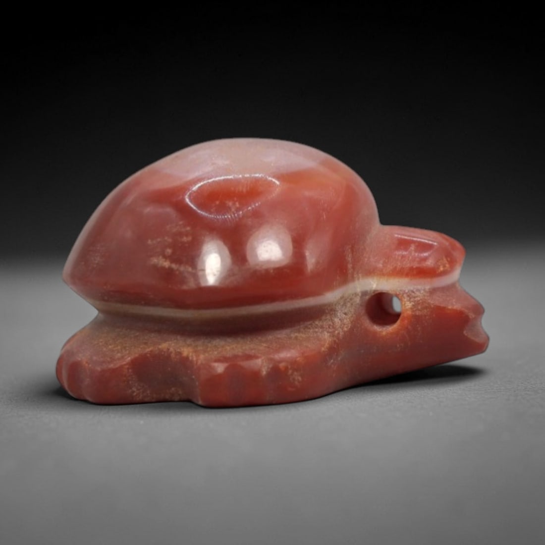 Antique Carnelian Agate Tortoise Amulet - Central Asian Longevity Talisman, 20ZW: Carved from deep red carnelian agate with a distinct creamy white horizontal band, this amulet takes the form of a stylized tortoise with a domed, glossy shell and simplified, robust limbs. A side per