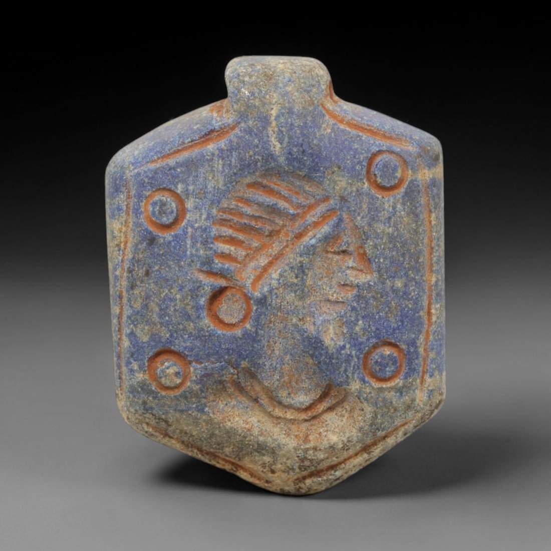 Ancient Lapis Lazuli Amulet - Near Eastern Portrait Pendant, 53ZX: Carved from lapis lazuli, the amulet is a hexagonal plaque with a raised suspension lug at the top, crafted in the style of ancient Near Eastern decorative arts. The surface bears an intaglio portrait