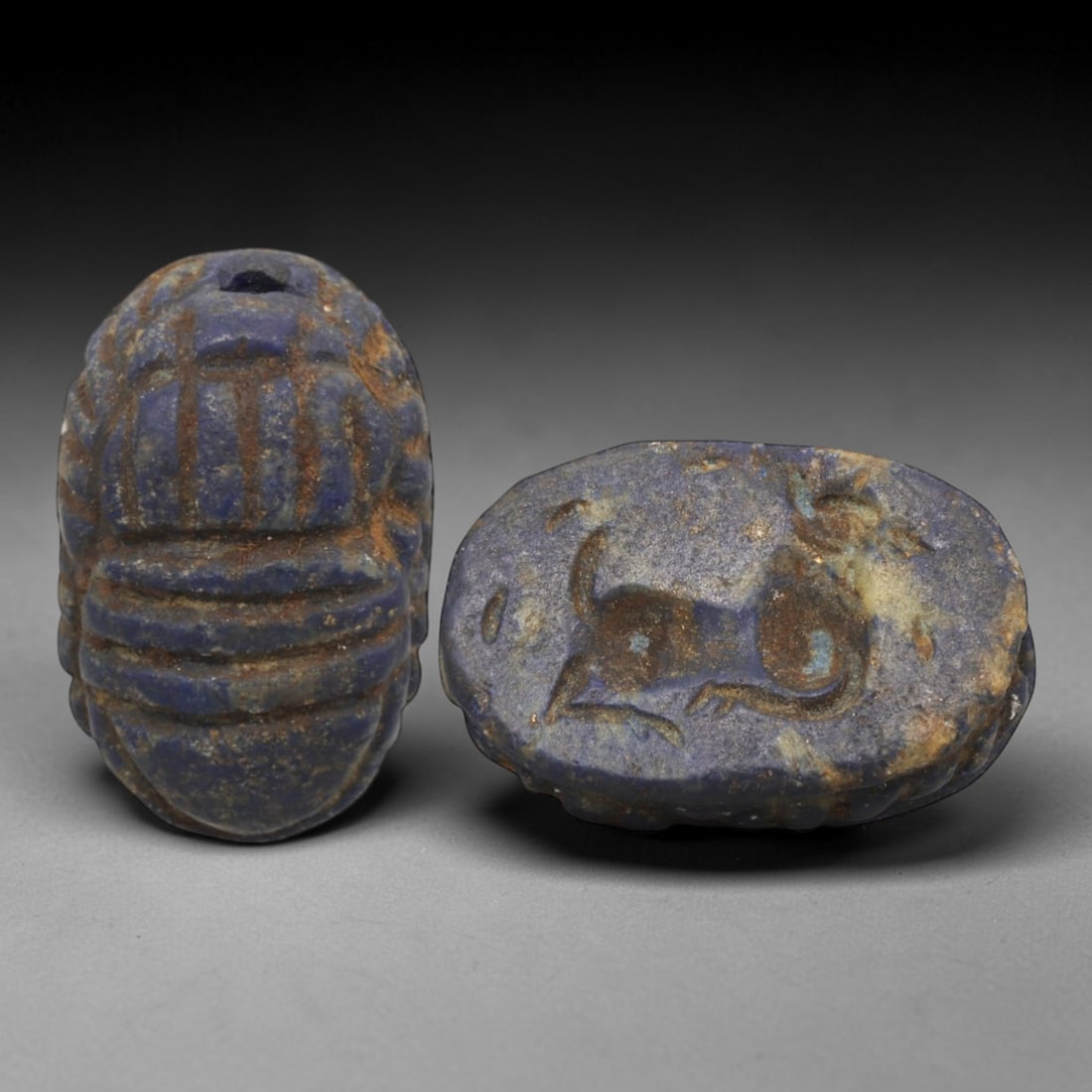 Ancient Lapis Lazuli Scarab - Near Eastern Zoomorphic Seal, 40XT: This artifact is hand-carved from lapis lazuli, employing traditional ancient lapidary techniques consistent with Near Eastern Bronze Age seal craftsmanship. The object takes the form of a scarab beet