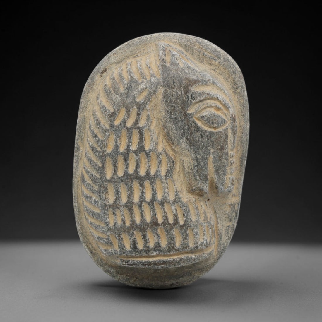 Ancient Stone Amulet - Near Eastern Horse Plaque, 89ZT: Carved from stone, this amulet plaque features a relief depiction of a horse head in profile, rendered in a stylized ancient Near Eastern iconographic tradition. The carving includes incised details d