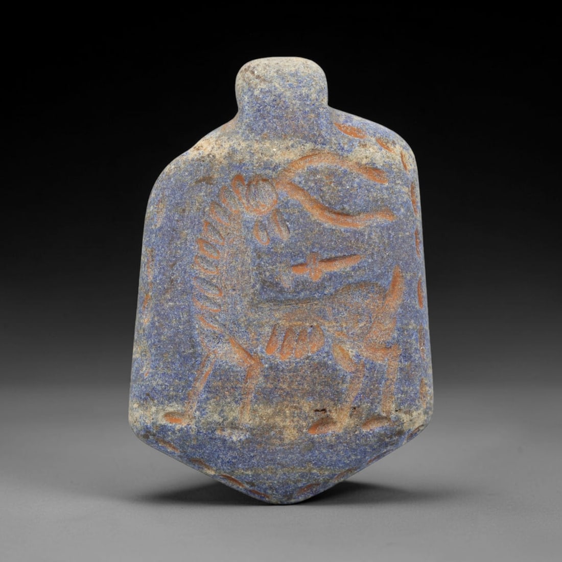 Ancient Lapis Lazuli Amulet - Near Eastern Animal Pendant, 8ZX: Carved from lapis lazuli, the amulet is shaped as a flattened, trapezoidal pendant with a raised suspension lug at the top. The front surface is incised with a stylized quadrupedal animal figure, rend
