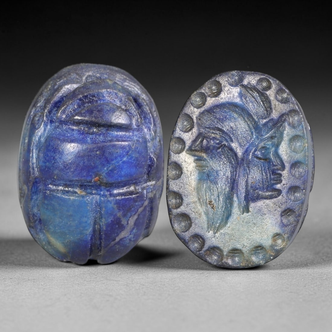 Ancient Lapis Lazuli Scarab - Near Eastern Janiform Seal, 59AS: This artifact is hand-carved from lapis lazuli, employing traditional ancient lapidary techniques consistent with Near Eastern Bronze Age seal craftsmanship. The object takes the form of a scarab beet