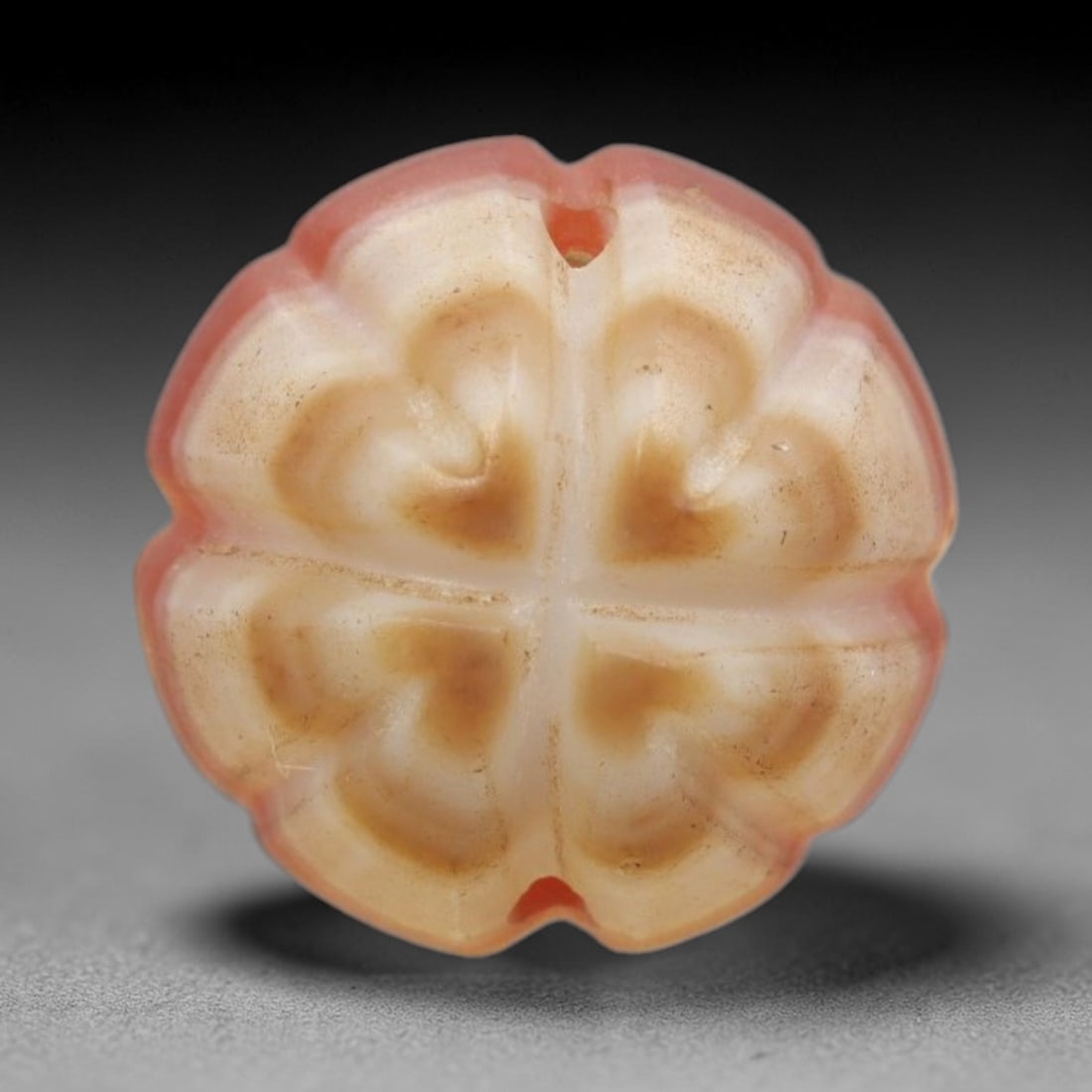 Antique Agate Eight-Petaled Flower Bead - Central Asian Carved Gemstone, 4ZW: Carved from banded agate with a soft pinkish-red outer edge and creamy white-tan core, this bead features a symmetrical eight-petaled floral form with deeply carved, heart-shaped petal segments arrang