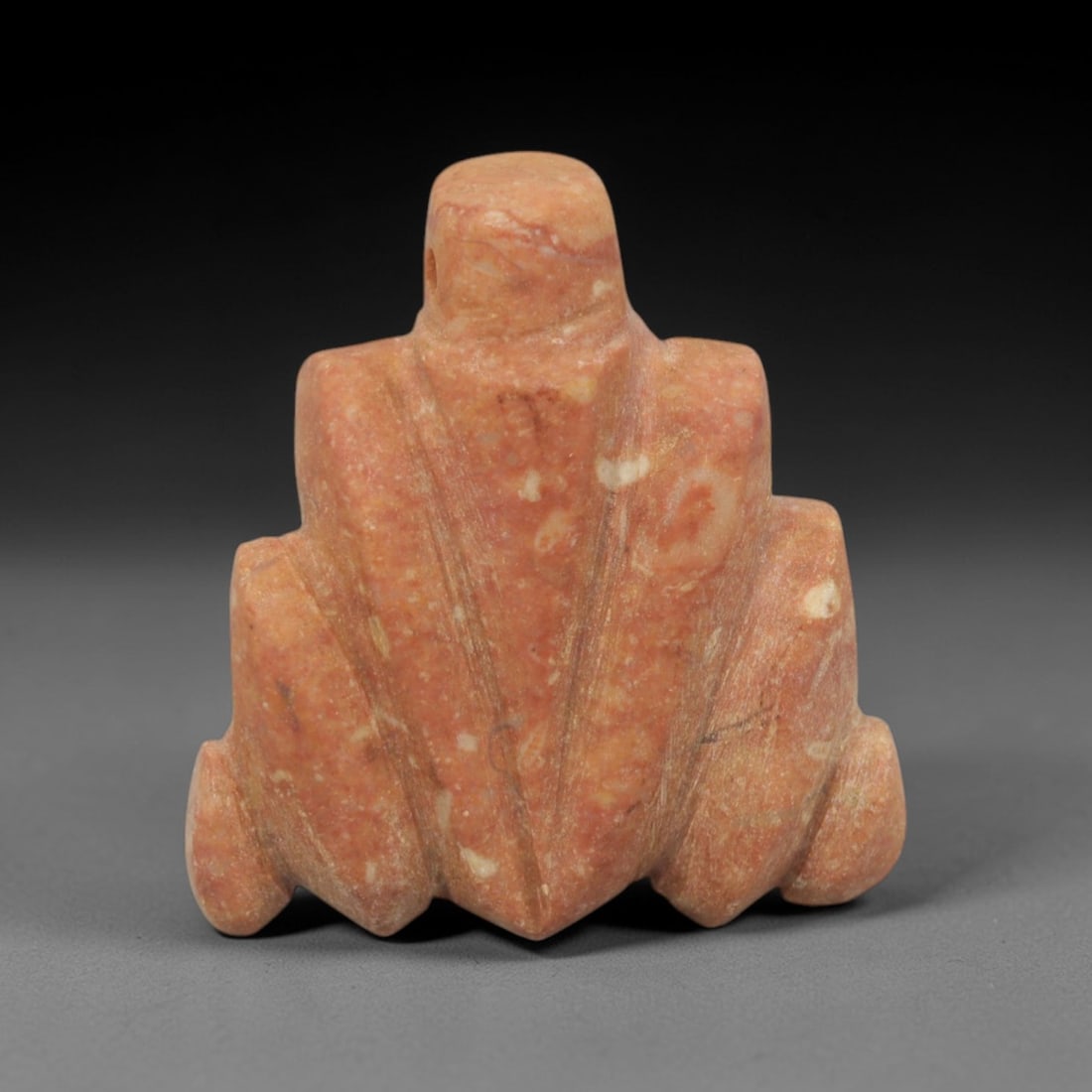 Ancient Pink Stone Frog-Form Amulet - Near Eastern Ritual Pendant, 3XQ: Carved from a warm, pinkish-tan stone with natural white and grey mineral inclusions, this charming amulet depicts a stylized frog, a beloved motif in ancient Near Eastern and Mediterranean ritual art