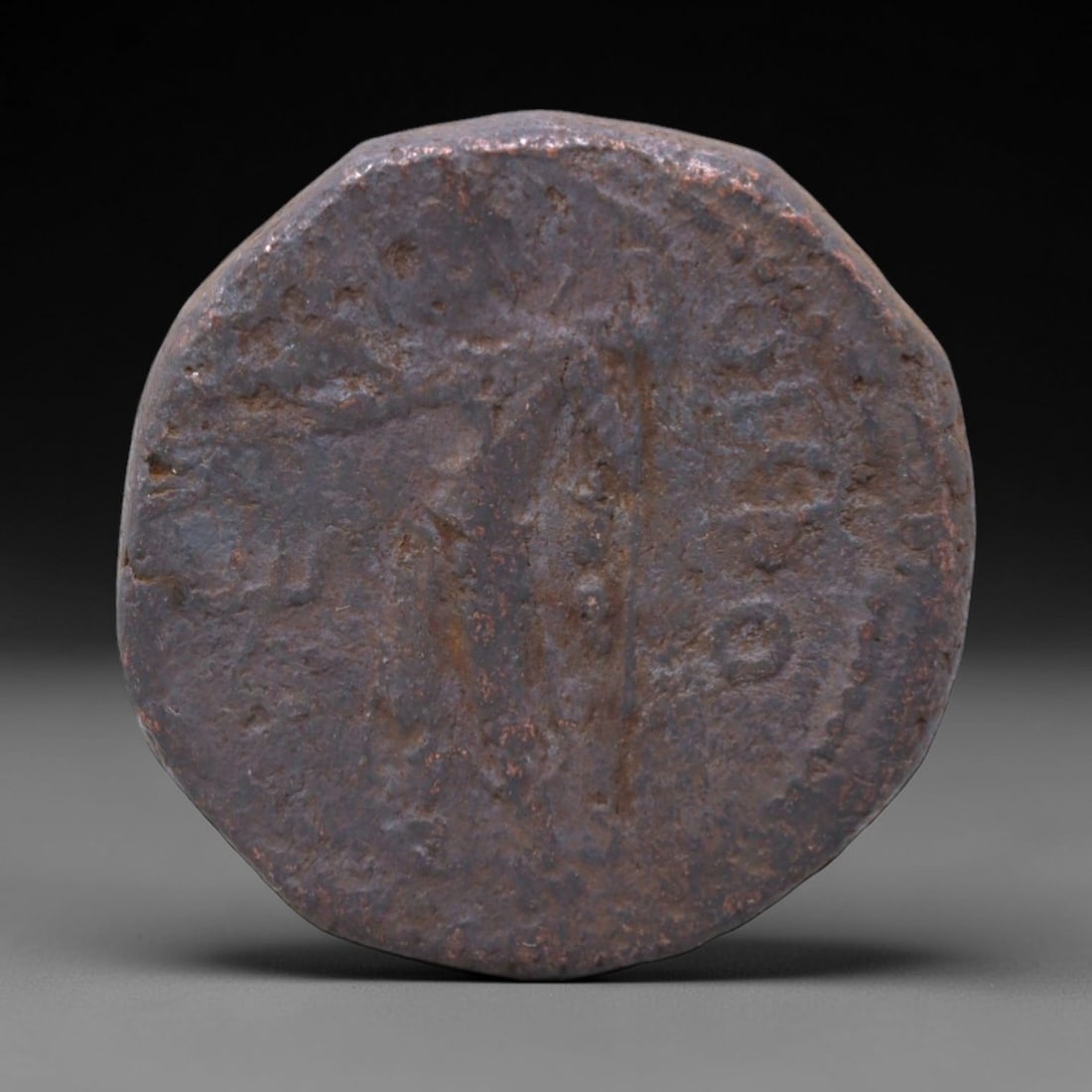 KUSHAN EMPIRE: Divine Sovereignty - Bronze Tetradrachm Coin, 25mm, 11XS: Minted during the height of Kushan imperial power, this bronze tetradrachm embodies the syncretic religious and political vision of the dynasty. A standing deity, rendered in classical Hellenistic sty