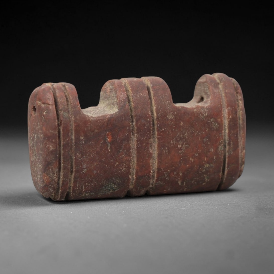 Ancient Mesopotamian Red Stone Double Horned Amulet - Carved Pendant Figure, 39ZV: This amulet is carved from a rich, deep red stone with natural mineral speckling and patination, likely brecciated jasper or red steatite, featuring a distinctive double-horned (or double-peaked) rect