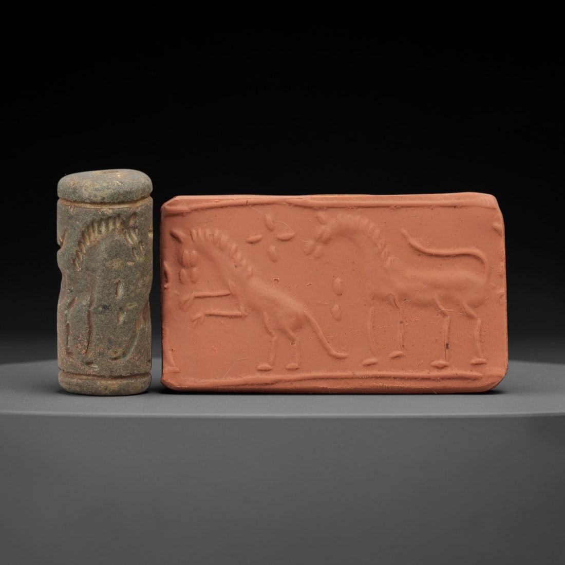 Ancient Near Eastern Stone Cylinder Seal - Horse Motif, 72AH: Carved from fine-grained stone, this cylinder seal features incised depictions of equine figures with detailed rendering of manes and limbs, a motif characteristic of ancient Near Eastern glyptic art.