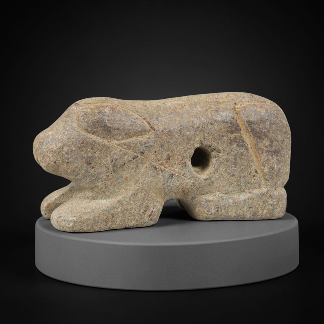 Ancient Schist Recumbent Zoomorphic Amulet - Near Eastern Carved Figurine, 72FY: Carved from schist, this amulet takes the form of a stylized recumbent zoomorphic figure (likely a rabbit, hare, or protective feline), rendered in three dimensions with simplified, bold carving. A dr