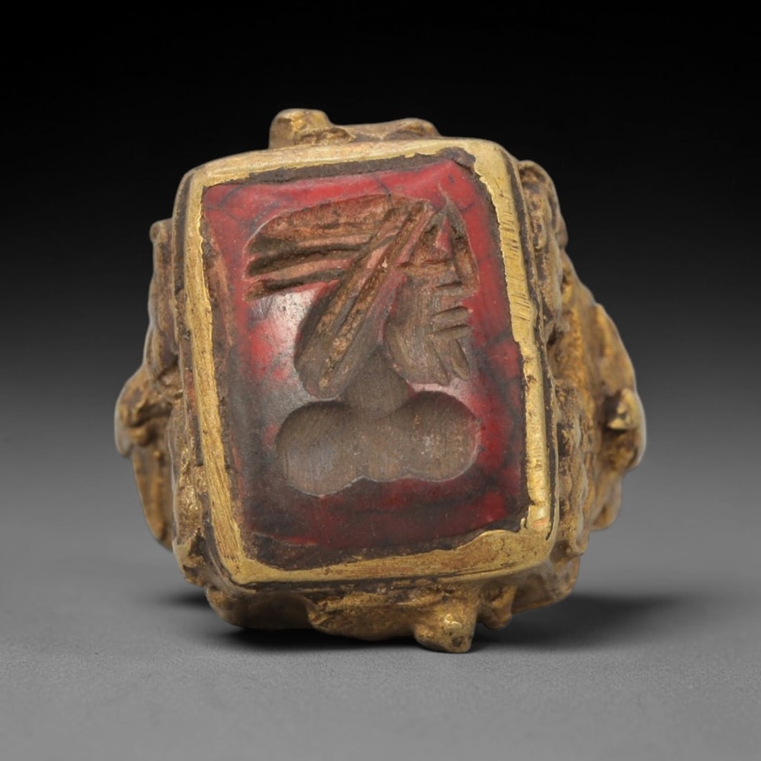 Antique Qajar Dynasty Brass Carnelian Intaglio Ring - Size 6 US, 89ZX: This antique Qajar dynasty brass intaglio ring features a rectangular carnelian intaglio inset carved with a detailed profile portrait of a bearded figure, set within an ornate, sculpted brass mount w