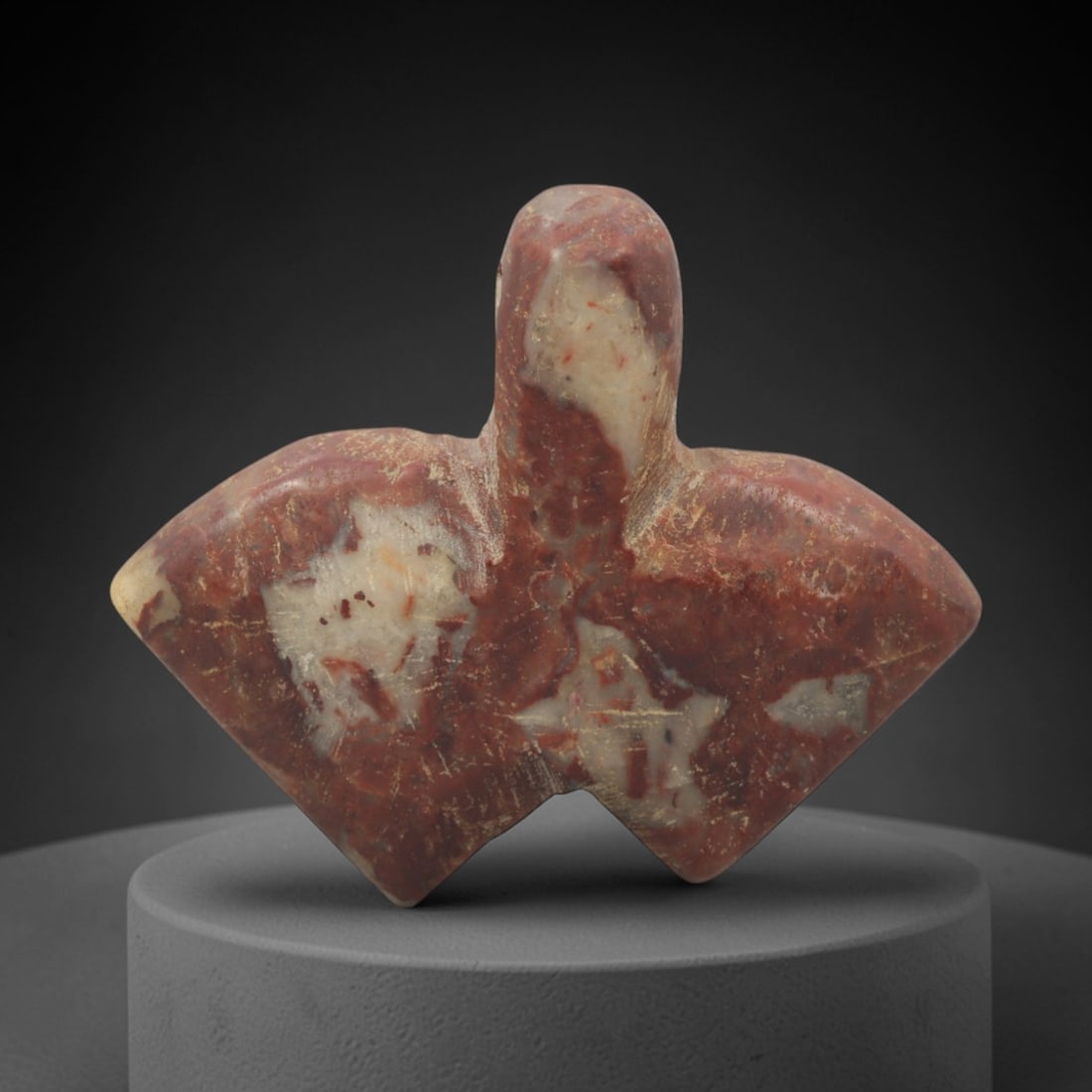 Ancient Stone Fly Amulet - Egyptian Ritual Figurine, 94XQ: Carved from a variegated reddish-brown stone with prominent pale inclusions, this amulet depicts a stylized fly form with a rounded head and broad, diamond-shaped wings extending horizontally. The smo