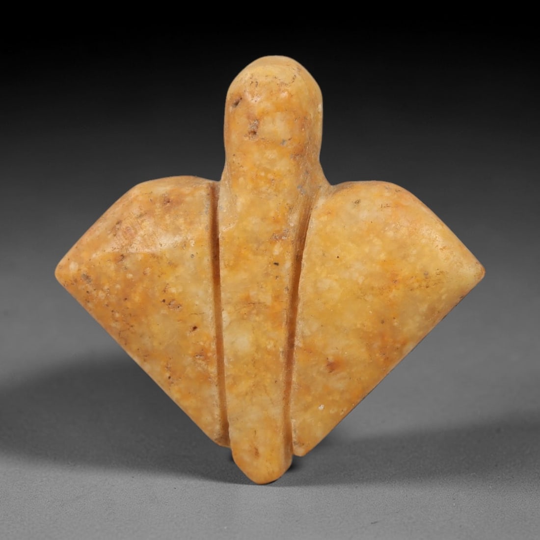 Ancient Beige Stone Amulet - Egyptian Style Figurine, 99AE: Carved from beige stone, this ancient Egyptian-style amulet features a compact, triangular form with incised linear details and a suspension hole at the top, indicating its use as a wearable amulet. T