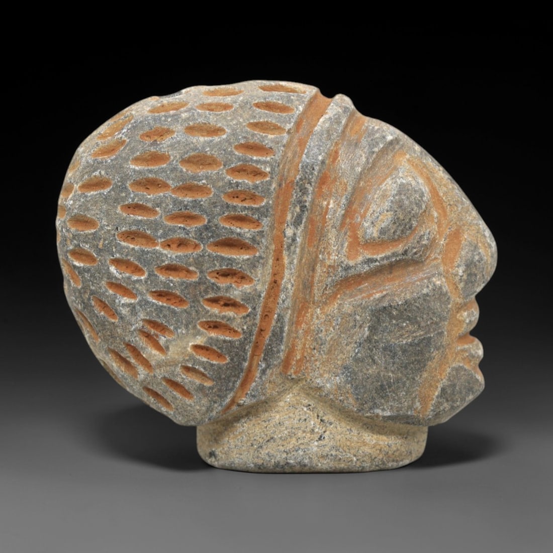 Ancient Stone Anthropomorphic Head Figurine - Mediterranean / Near Eastern Ritual Artifact, 10ZR: This artifact is a carved stone anthropomorphic head figurine, executed in the stylized profile tradition of the ancient Mediterranean or Near East. The head features a textured, dotted headdress (lik