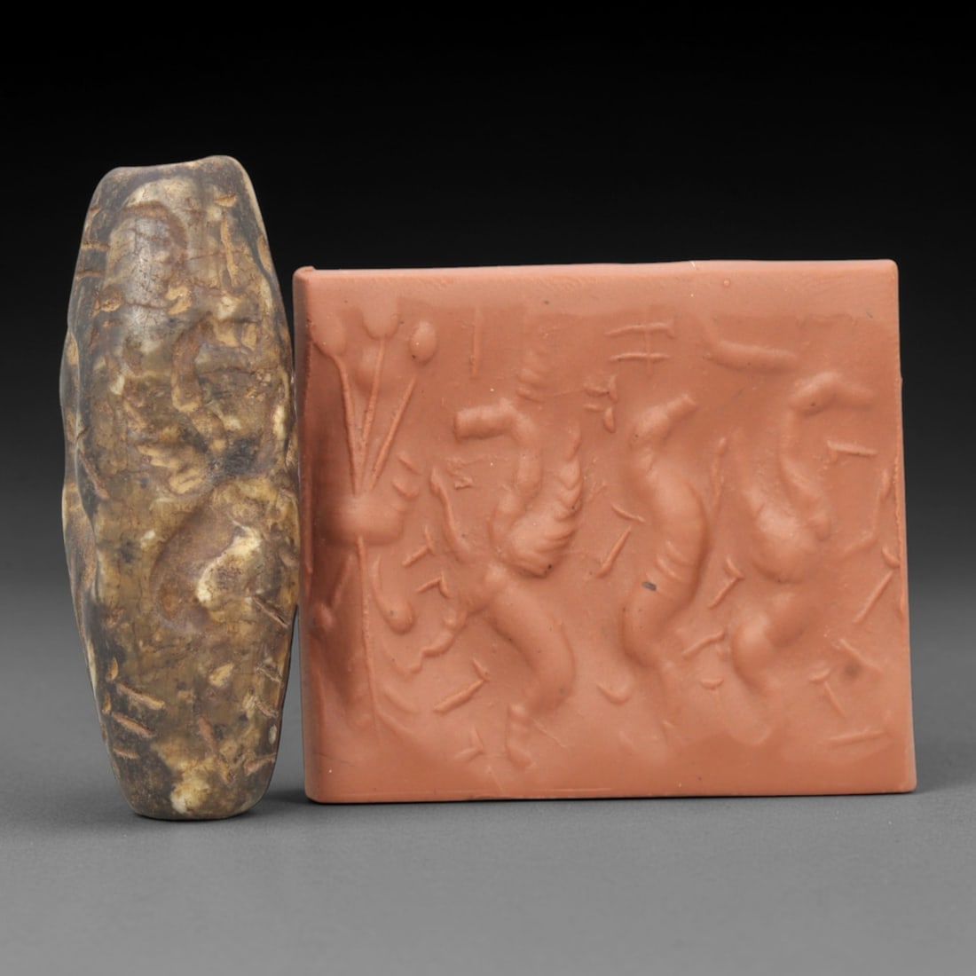 Ancient Steatite Cylinder Seal - Mesopotamian Mythological Carving, 82ZR: Crafted from dense steatite, this ancient Mesopotamian cylinder seal displays precise hand-carved iconography featuring a winged anthropomorphic figure and animal motifs, executed in the linear relief