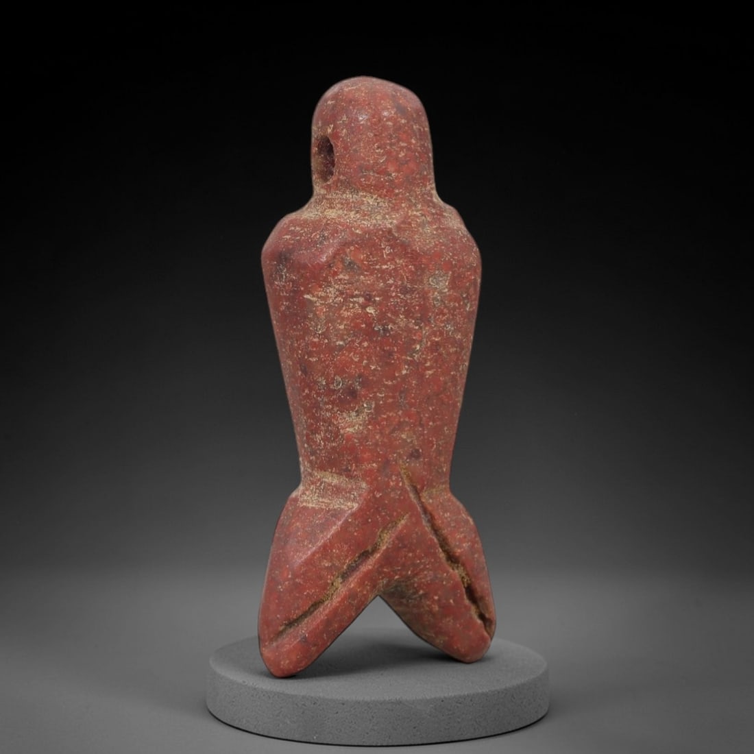 Ancient Egyptian Stone Amulet - Anthropomorphic Carved Pendant, 34AE: Carved from reddish-brown stone, this ancient Egyptian amulet features an anthropomorphic form with a suspension hole at the top and a three-pronged base, a motif typical of Egyptian protective amulet