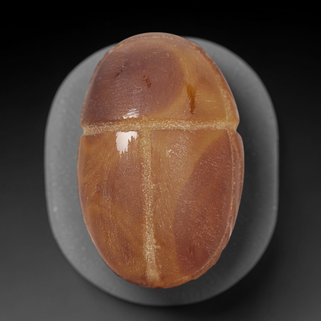 Ancient Banded Agate Scarab Amulet - Egyptian Figurine, 29XS: Carved from warm banded agate with natural amber and deep brown tonal gradients, this amulet is formed as a stylized scarab beetle with incised linear detailing to define the central body ridge and se