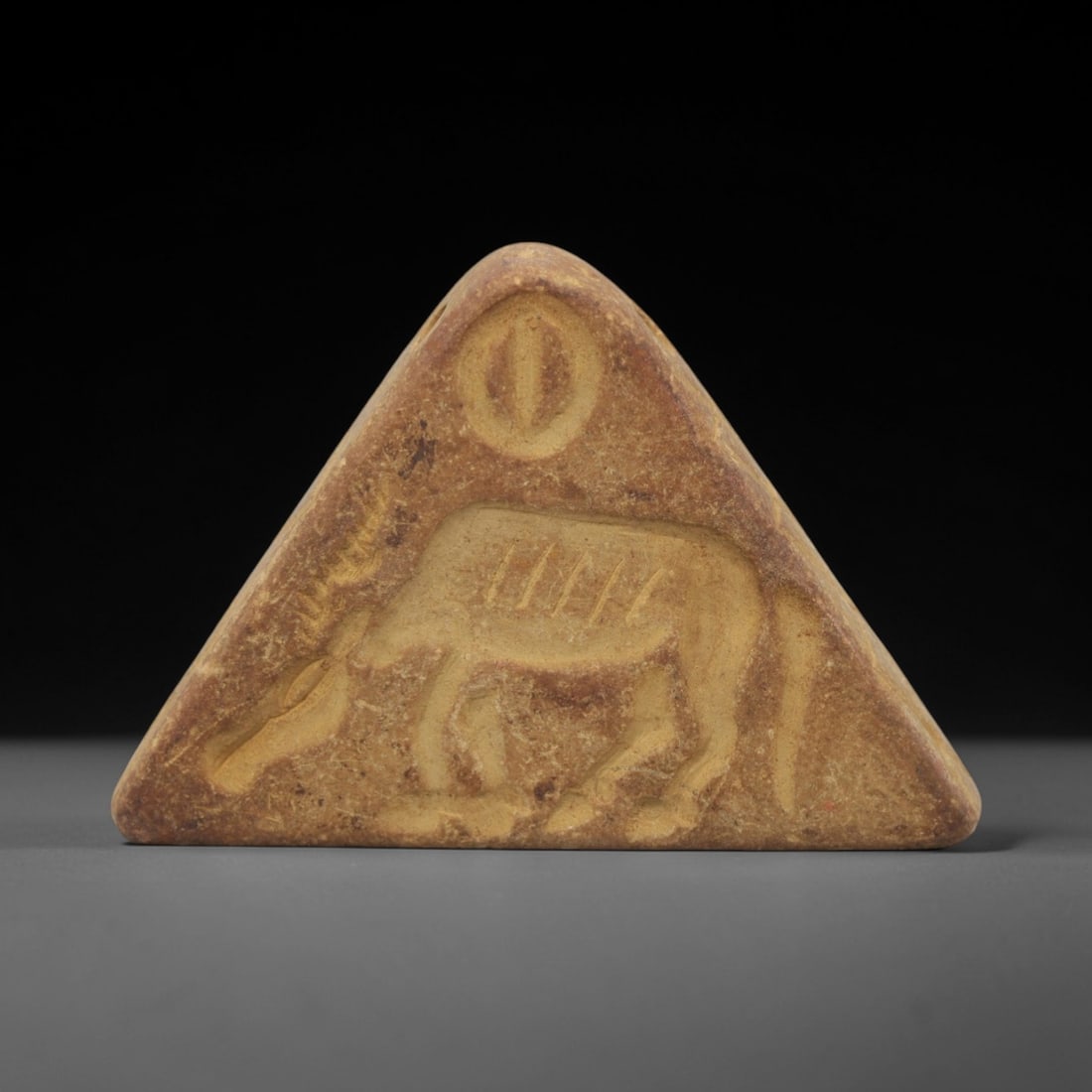 Ancient Near Eastern Stone Double Convex Stamp Seal - Stag Motif, 31AH: Carved from fine-grained stone, this double convex stamp seal features incised depictions of paired stags, a motif characteristic of ancient Near Eastern glyptic art. The piece exhibits a natural redd