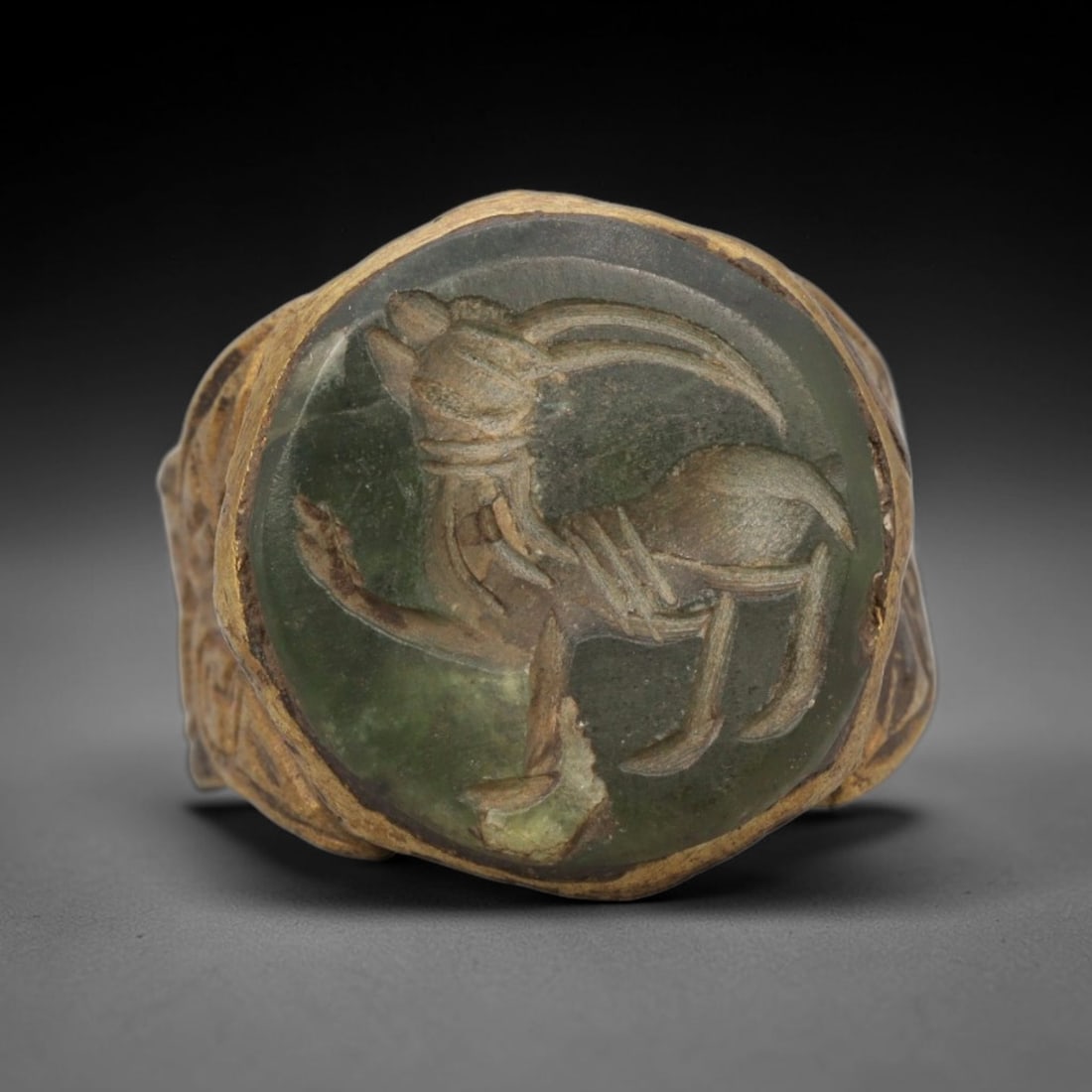 Antique Qajar Dynasty Brass Intaglio Ring - Size 9 US, 92ZX: This antique Qajar dynasty brass intaglio ring features a finely carved ibex motif, a traditional decorative subject in Qajar-era metalwork. The ring is crafted from brass, with a green-stone intaglio