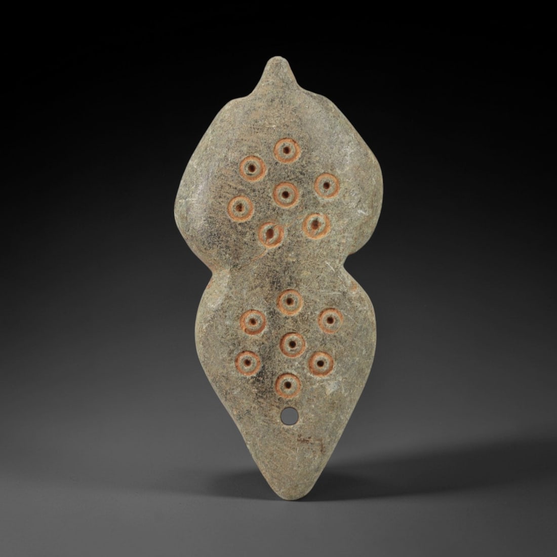 Ancient Steatite Amulet - Near Eastern Double Lobed Figurine, 95AK: Carved from steatite, this amulet features a double-lobed, gourd-like form with incised circular motifs, each containing a central dot, arranged symmetrically across both lobes, with a suspension hole