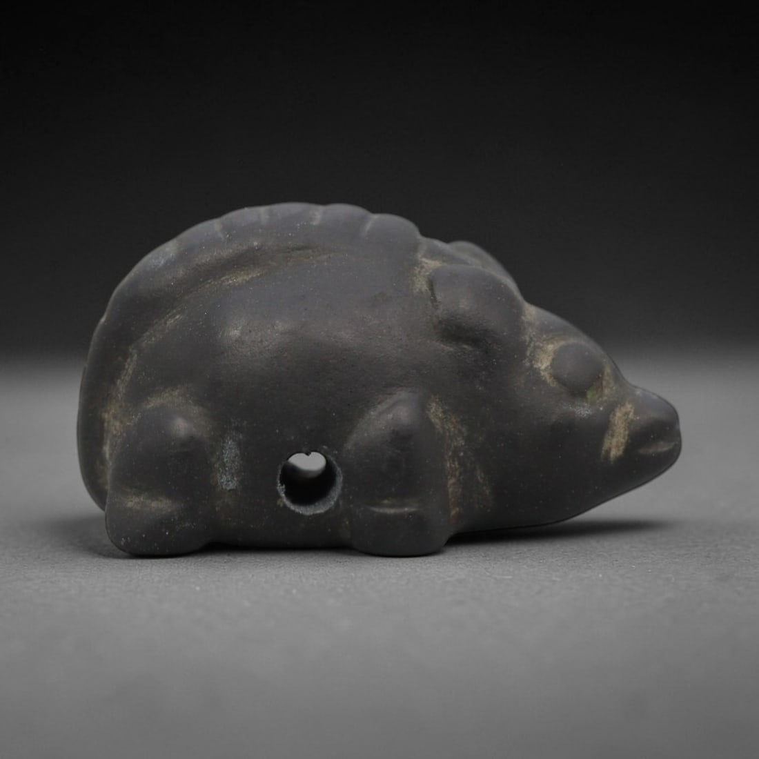 Ancient Near Eastern Stone Rodent Amulet - Carved Figurine, 97ZW: This amulet is carved from a dense, dark grey stone, likely basalt or a similar hard igneous rock, with subtle raised and incised details defining its rodent form. The piece features a rounded, compac