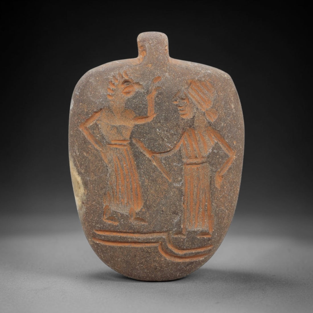 Ancient Stone Amulet - Near Eastern Human & Bird Figure, 93ZT: Carved from stone, this amulet features a relief scene depicting two standing figures: a human figure holding a blade, confronting a bird-headed anthropomorphic figure, rendered in the stylized glypti