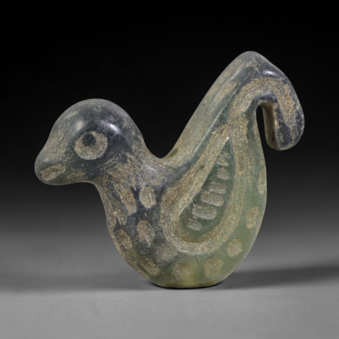 Ancient Serpentine Bird Amulet - Near Eastern Figurine, 87AR: This artifact is carved from pale, translucent green serpentine, exhibiting a smooth, polished surface with subtle natural inclusions and faint surface wear consistent with age. The form is a stylized