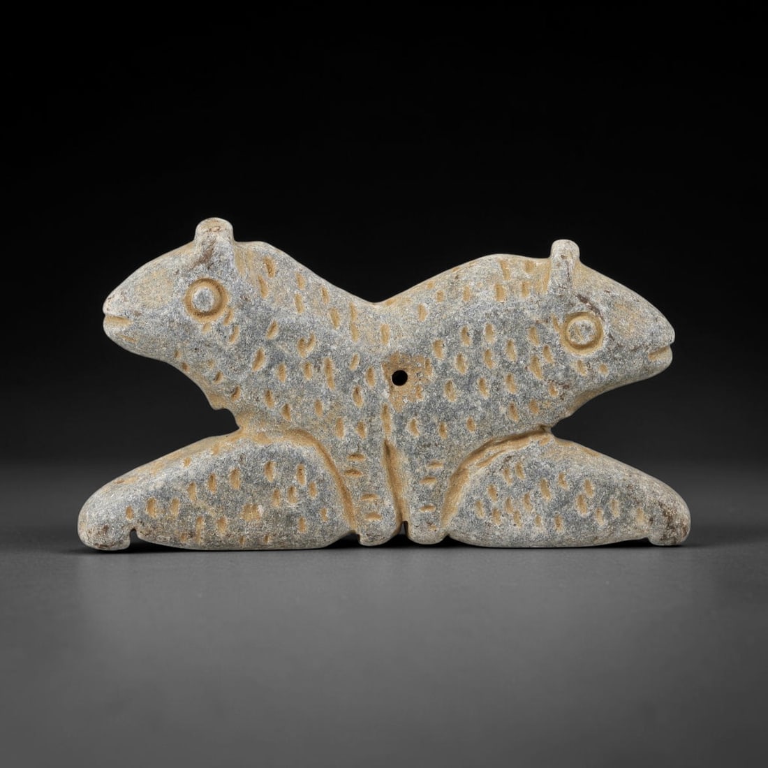 Ancient Schist Double-Headed Zoomorphic Amulet - Near Eastern Carved Pendant, 49BA: Carved from schist, this amulet takes the form of a stylized, three-dimensional double-headed zoomorphic figure (a protective composite beast, likely combining feline or equine symbolic features), ren
