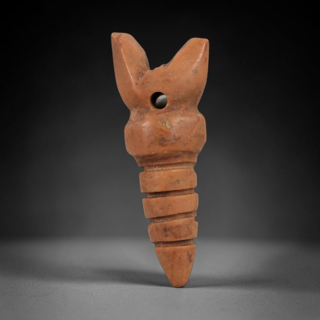 Ancient Egyptian Stone Amulet - Elongated Carved Form, 13AG: Carved from stone, this ancient Egyptian amulet features an elongated, tapering form with incised detailing, typical of protective amulets from the Late Period (c. 664-332 BCE). The simple, streamline