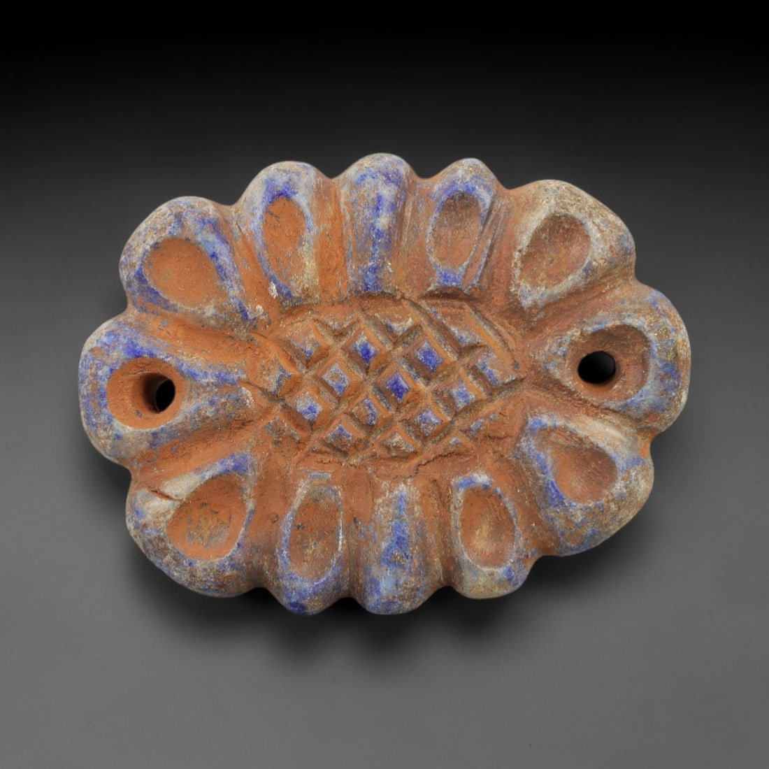 Ancient Lapis Bead - Achaemenid Amulet, 9AH: Carved from lapis lazuli, this ancient Achaemenid lapis bead features a lobed form with intricate geometric detailing typical of Achaemenid glyptic art. The material exhibits deep blue coloration with