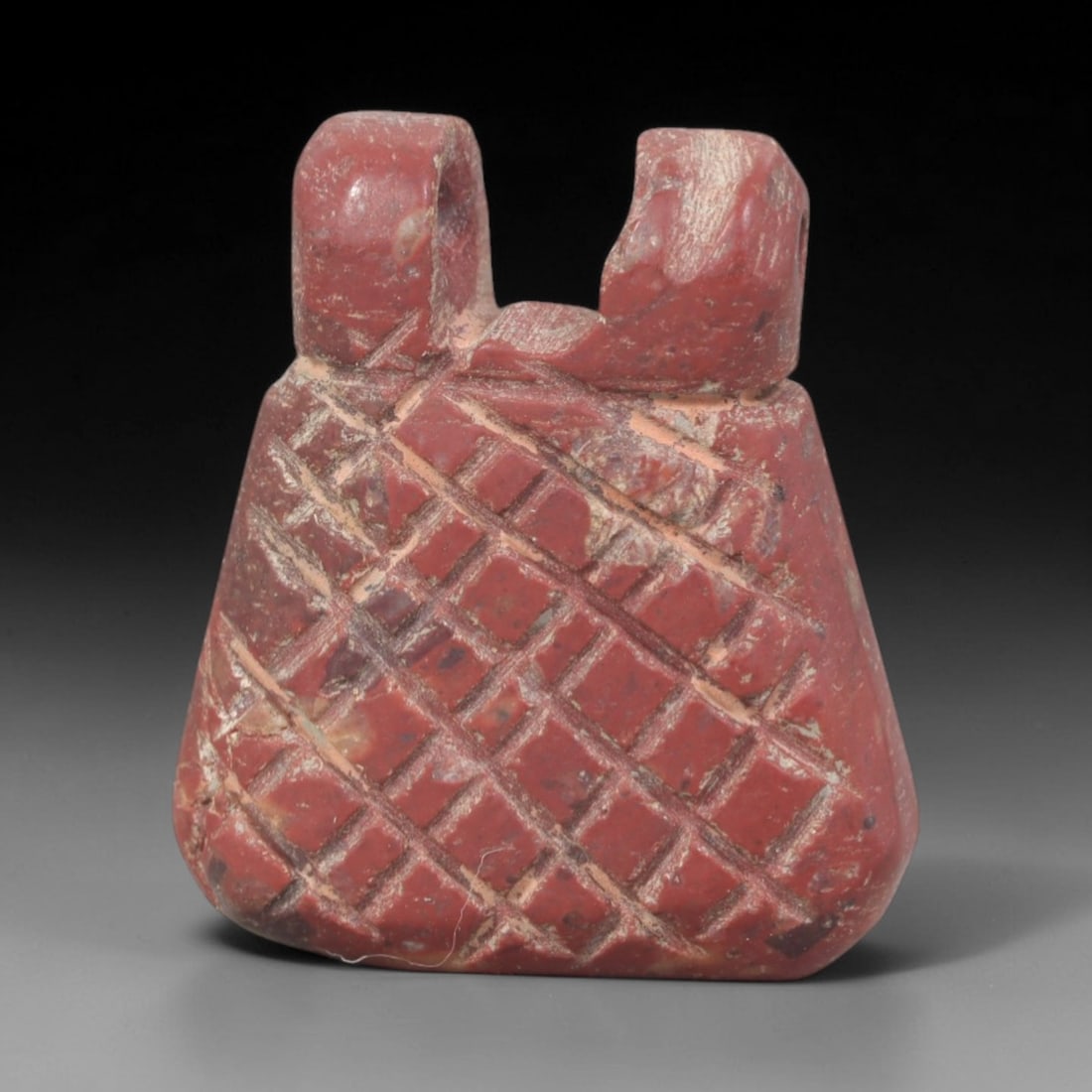 Ancient Tyet (Knot of Isis) Amulet - Egyptian Ritual Pendant, 54AP: This artifact is carved from variegated red stone with a weathered, earthy patina and natural mineral inclusions, exhibiting the iconic form of the Egyptian Tyet (Knot of Isis), consistent with ancien