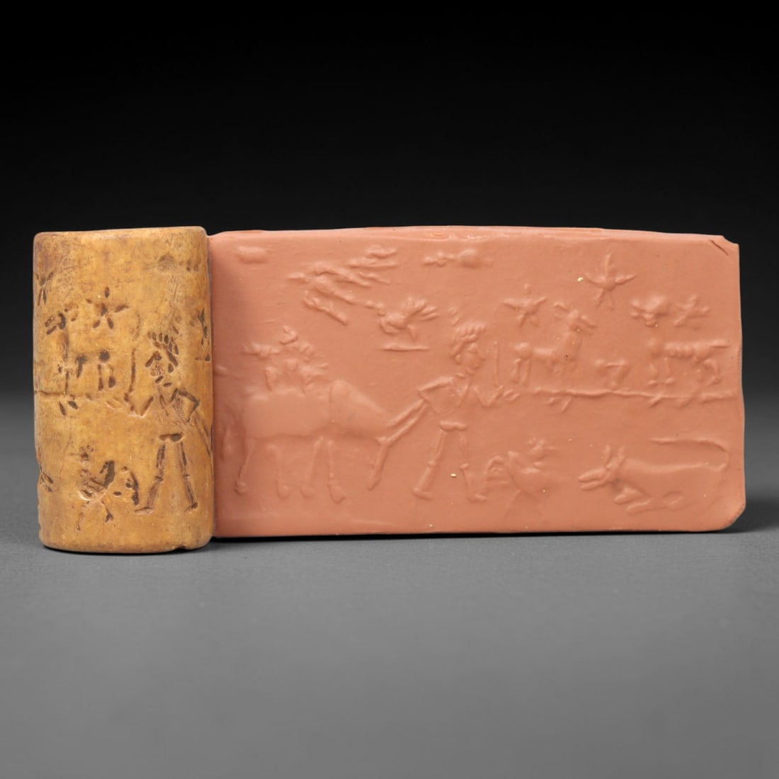 Ancient Steatite Cylinder Seal - Mesopotamian Pastoral Hunt Scene, 20ZP: Carved from warm, honey-toned steatite, this ancient cylinder seal depicts a lively pastoral hunting scene, executed with precise glyptic craftsmanship characteristic of the Early Mesopotamian period.