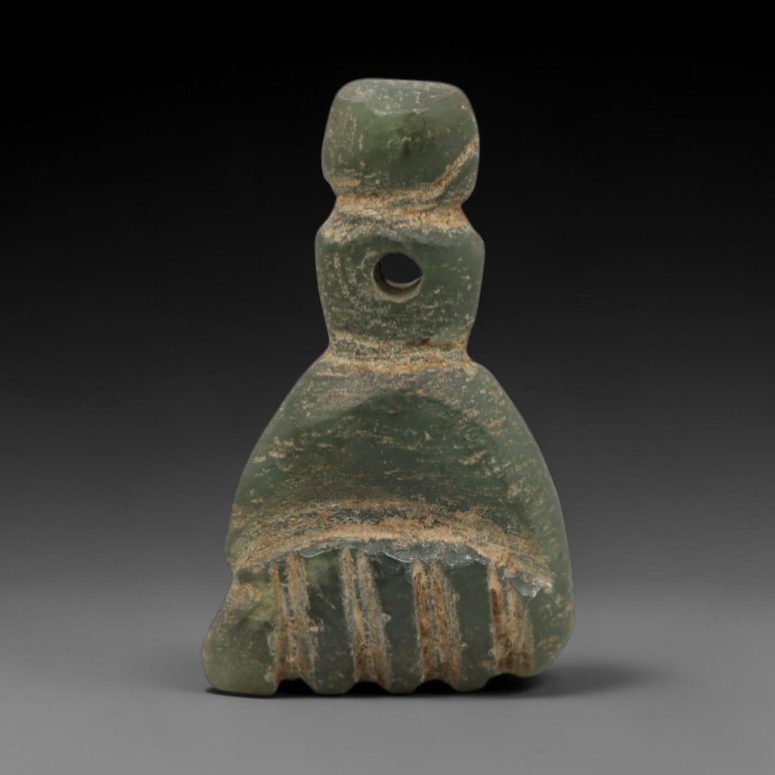 Ancient Near Eastern Serpentine Fist Amulet - Carved Pendant Figure, 85ZW: This amulet is carved from a rich, muted green serpentine stone, with incised linear details defining its stylized clenched fist form. The piece features a rounded suspension loop at the top with a dr