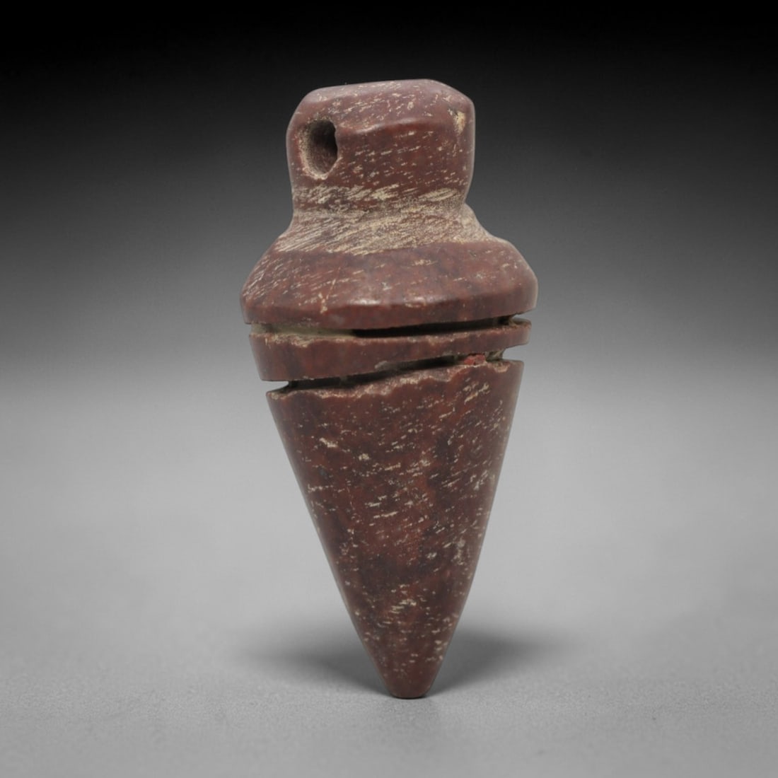 Ancient Near Eastern Red Stone Segmented Conical Amulet - Carved Pendant Figure, 98ZW: This amulet is carved from a rich, deep red stone with natural mineral speckling and patination, likely brecciated jasper or red steatite, featuring a robust segmented conical form. The piece consists