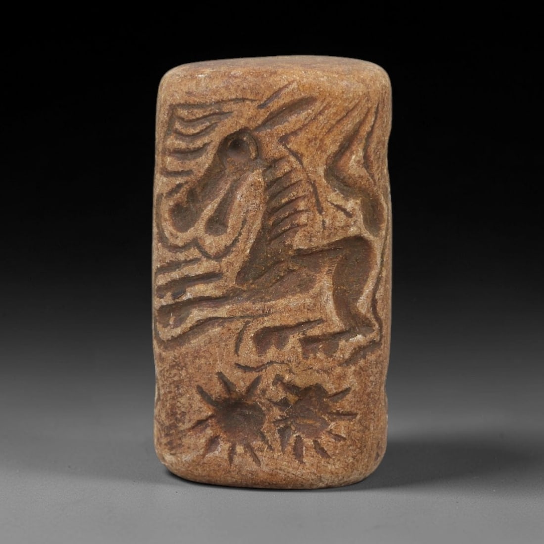 Ancient Schist Double Convex Bead - Perforated Stone Bead, 60AH: Carved from schist stone, this ancient double convex bead features a biconical form with a central perforation, typical of ornamental use in early cultural contexts. The stone exhibits a natural, eart