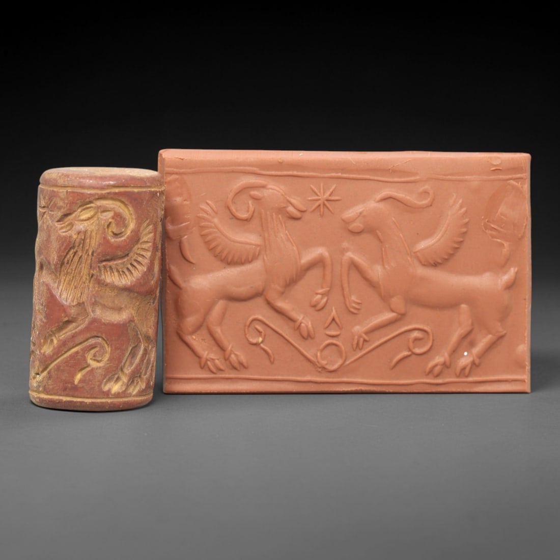 Ancient Steatite Cylinder Seal - Mesopotamian Winged Ibex Scene, 37AL: Carved from warm, earthy steatite, this ancient Mesopotamian cylinder seal depicts a symmetrical scene of confronting winged ibexes, executed with precise glyptic craftsmanship characteristic of Mesop