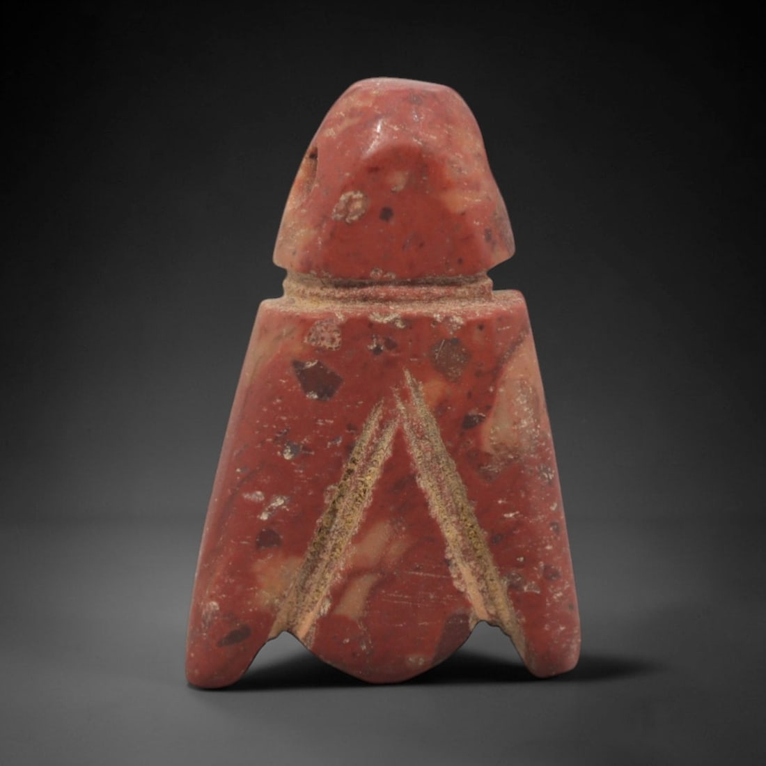 Ancient Egyptian Stone Fly Amulet - Carved Pendant Figure, 51ZV: This amulet is carved from a speckled, reddish brecciated stone, likely a type of siltstone or conglomerate, with incised linear details defining its stylized fly form. The piece features a rounded he
