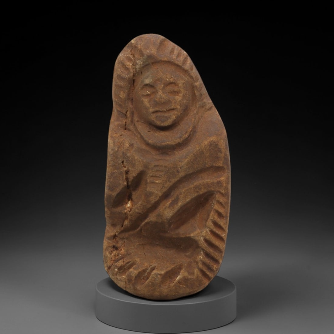 Ancient Style Stone Monk - Japanese Edo Figurine, 47FX: Carved from granular stone, this compact figure depicts a seated Edo-period monk in a meditative posture. The face is rendered with simplified, serene features: closed eyes, a broad nose, and a gently