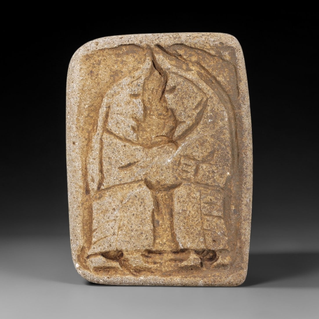 Ancient Stone Figural Amulet - Near Eastern Christian Pair, 4FY: Carved from a rectangular stone plaque, this piece features a bas-relief depiction of two standing figures, likely representing a Christian devotional pair, with incised lines defining their robes, po