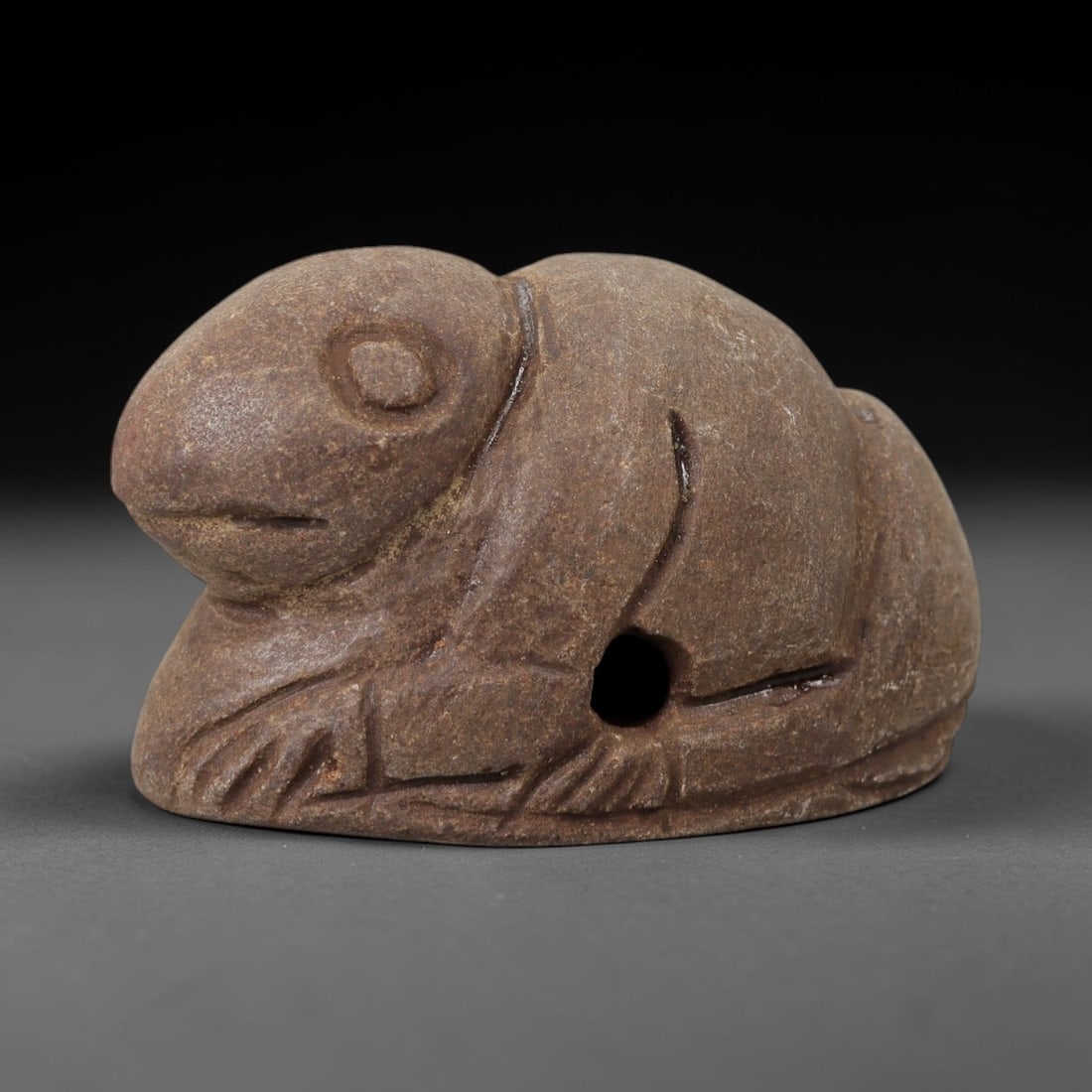 Ancient Steatite Lizard Amulet - Miniature Relic, 94AG: Carved from steatite, this ancient lizard amulet features a stylized, naturalistic rendering of a lizard with detailed facial features and a central perforation for suspension. The stone exhibits a mu