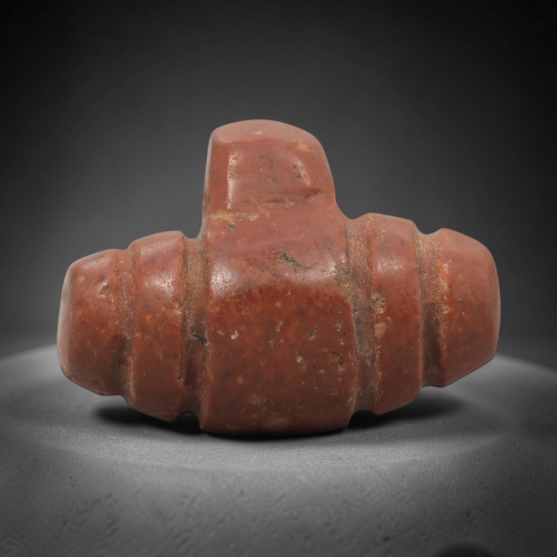 Ancient Near Eastern Red Stone Double Amulet - Carved Pendant Figure, 13ZV: This amulet is carved from a rich, reddish-brown stone, likely brecciated jasper or red steatite, with a symmetrical double-form design. The piece features a central rectangular block flanked by two r
