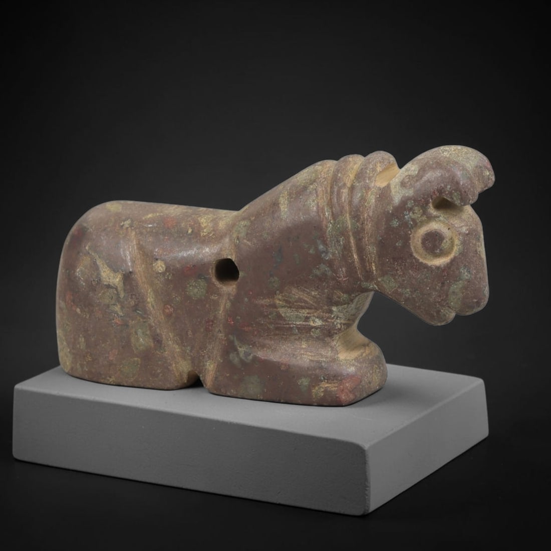 Ancient Stone Recumbent Bull Amulet - Near Eastern Carved Figurine, 75FY: Carved from polished, multi-hued hardstone (likely serpentine or steatite), this amulet takes the form of a stylized recumbent bull (a symbol of strength and protection in ancient Near Eastern culture