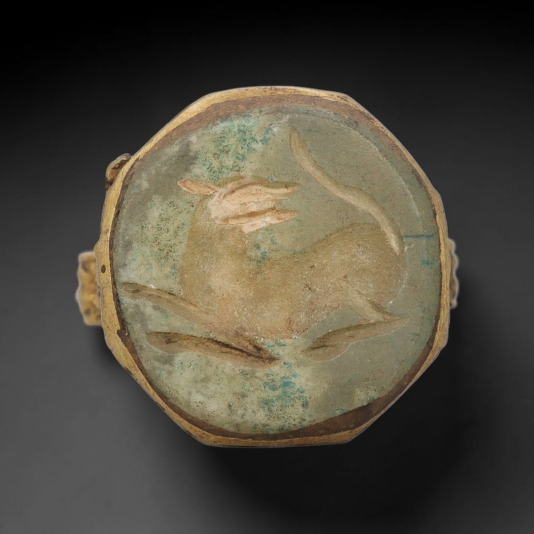 Antique Qajar Dynasty Brass Intaglio Ring - Size 9 US, 91ZX: This antique Qajar dynasty brass intaglio ring features an octagonal hardstone intaglio inset carved with a detailed stylized ibex motif, set within a brass mount with decorative side detailing. The r