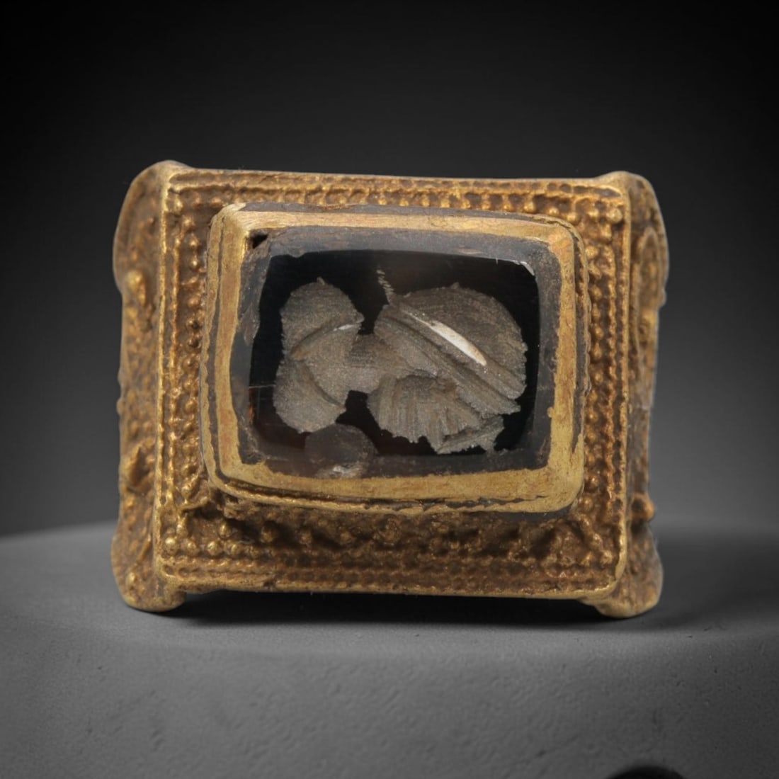 Antique Qajar Dynasty Brass Intaglio Ring - Size 8 US, 93ZX: This antique Qajar dynasty brass intaglio ring features a rectangular dark stone intaglio inset with incised figural carvings, set within an ornate square brass mount adorned with granular beading and
