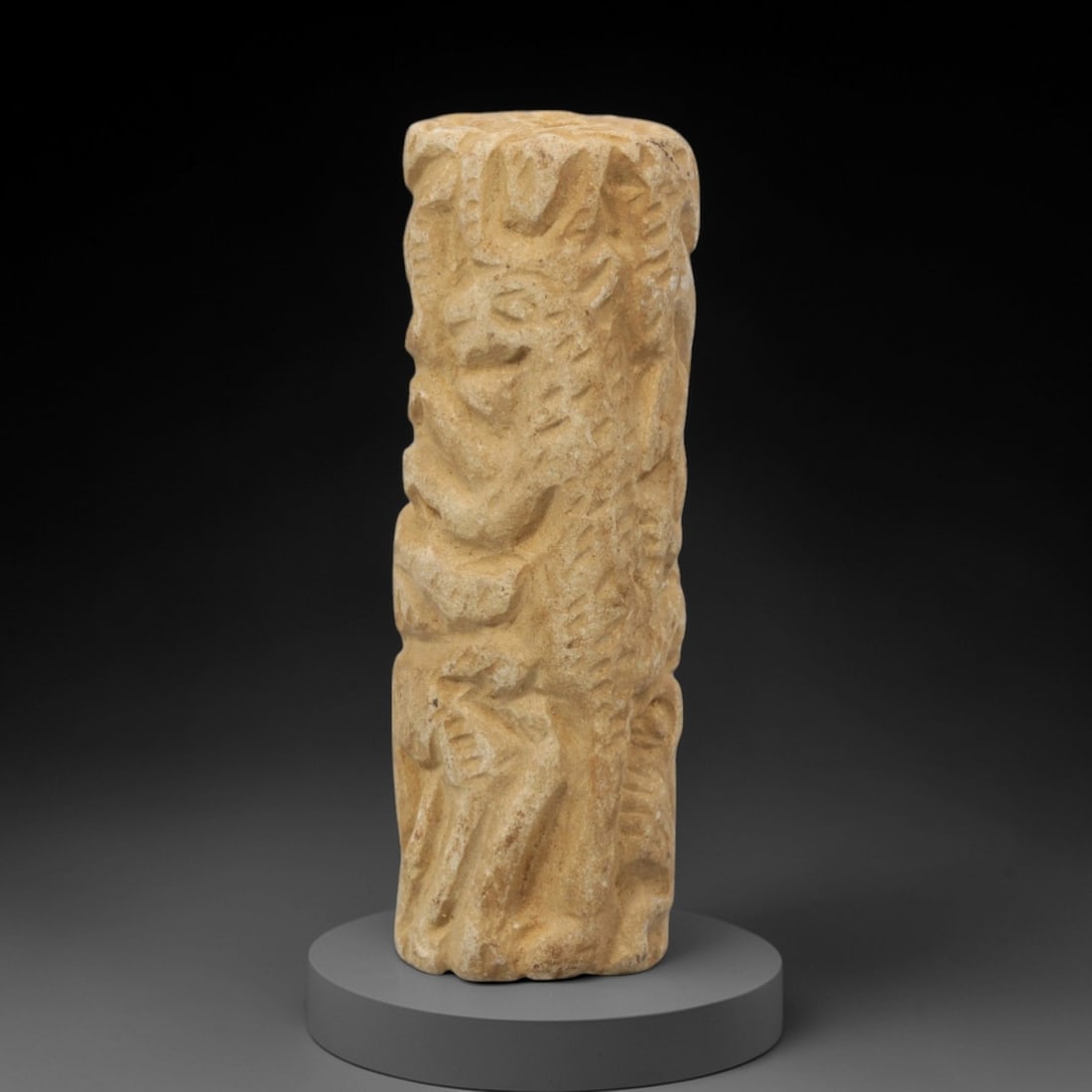 Ancient Limestone Anthropomorphic Bead - Near Eastern Carved Relief, 73ZQ: Carved from limestone, this ancient Near Eastern anthropomorphic bead features raised relief detailing along its cylindrical form, depicting stylized humanoid figures and geometric patterns typical of