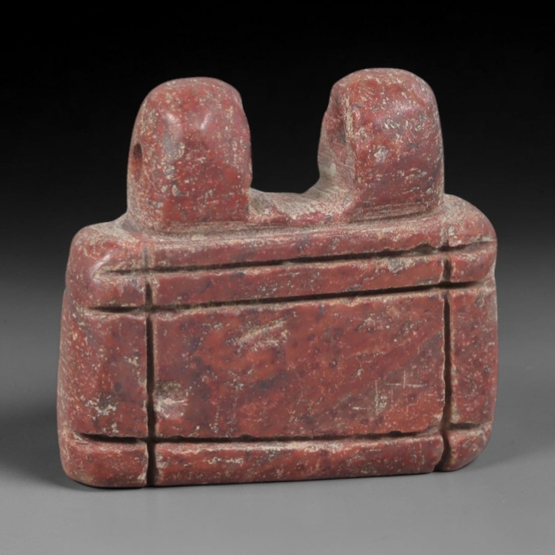 Ancient Stone Amulet - Egyptian Ritual Pendant, 93AP: This artifact is carved from variegated red stone with a weathered, earthy patina and natural mineral inclusions, exhibiting precise incised linear detailing consistent with ancient Egyptian stonework