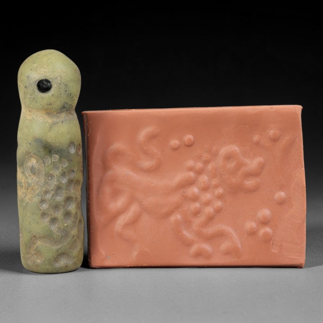 Ancient Serpentine Cylinder Seal - Mesopotamian Animal Motif, 84FX: Crafted from serpentine, this cylinder seal exhibits the characteristic cylindrical form of ancient Mesopotamian administrative and ritual objects. Its surface is carved with a dynamic animal motif, l