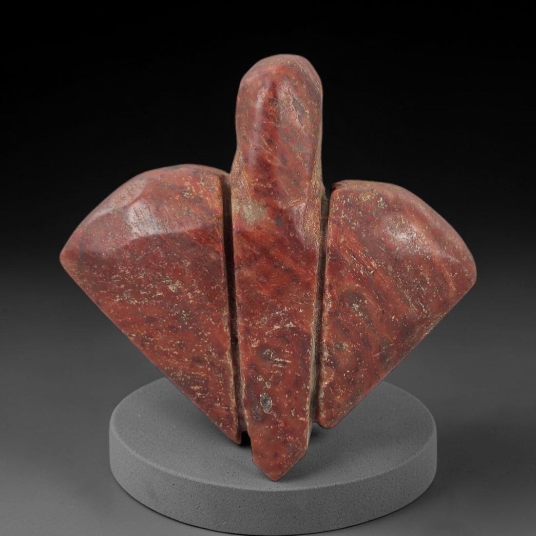 Ancient Egyptian Stone Amulet - Carved Ritual Figurine, 77AE: Carved from reddish-brown stone, this amulet features incised linear patterns and a tapered, notched base. The form is consistent with small Egyptian ritual amulets of the Late Period, crafted for pro