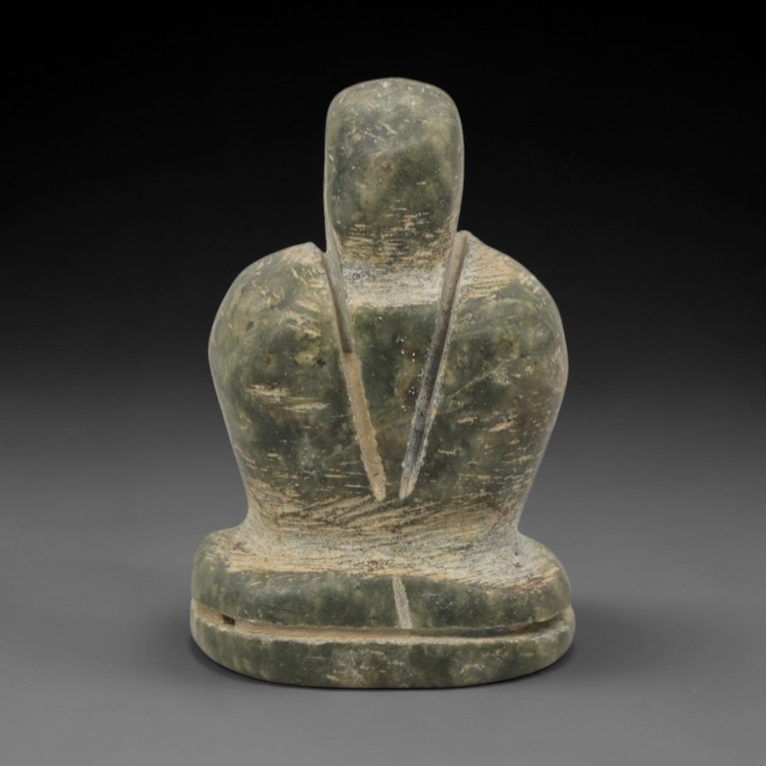 Ancient Stone Axehead Amulet - Near Eastern Pendant, 55XQ: This amulet is carved from a variegated greenish-grey stone, shaped into a stylized, abstract axehead form with a rounded upper knob and a perforated suspension hole at the top, confirming its use as